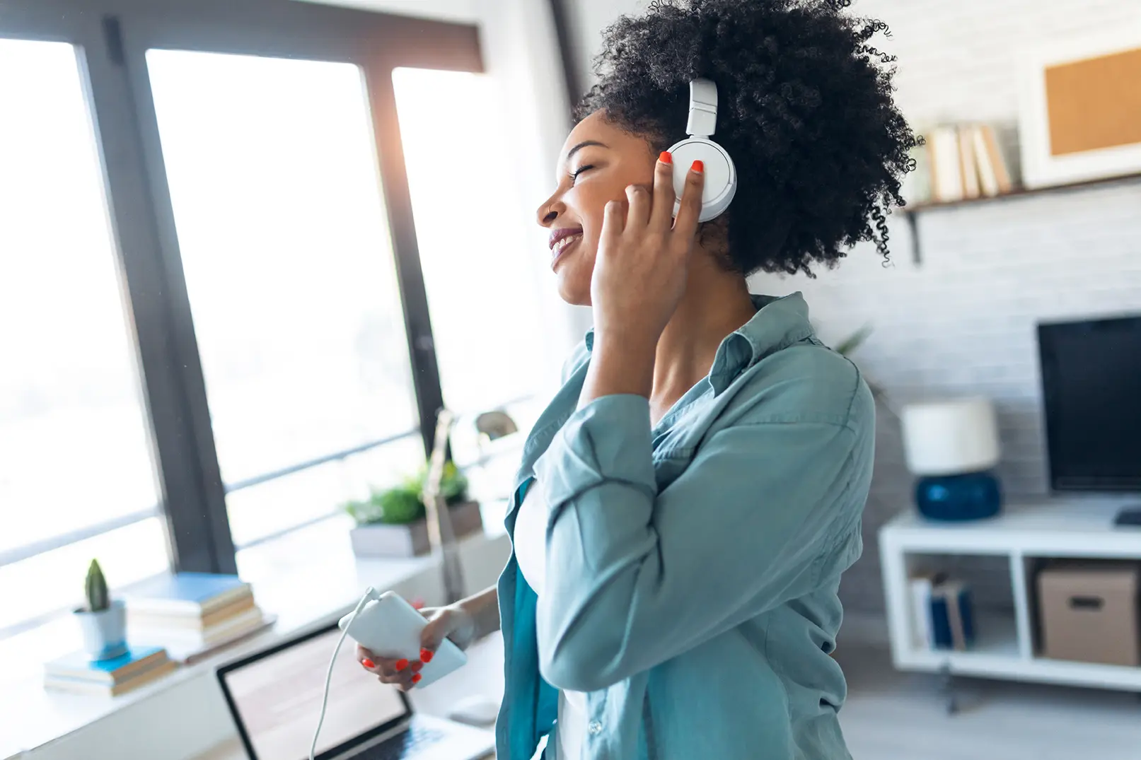 Young woman listening to digital audio streaming podcast